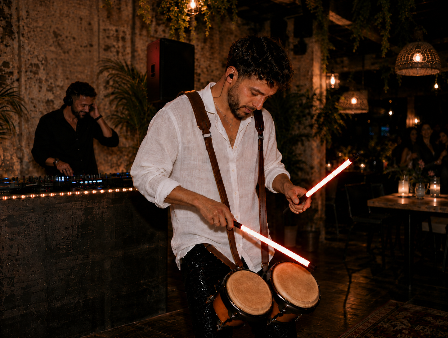 Percussionist performing with LED drumsticks at a wedding reception